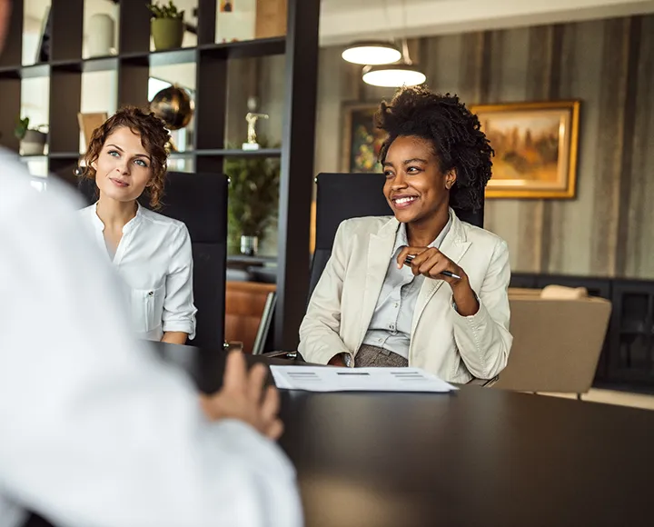 Two females having a meeting together in the office Two females having a meeting together in the office