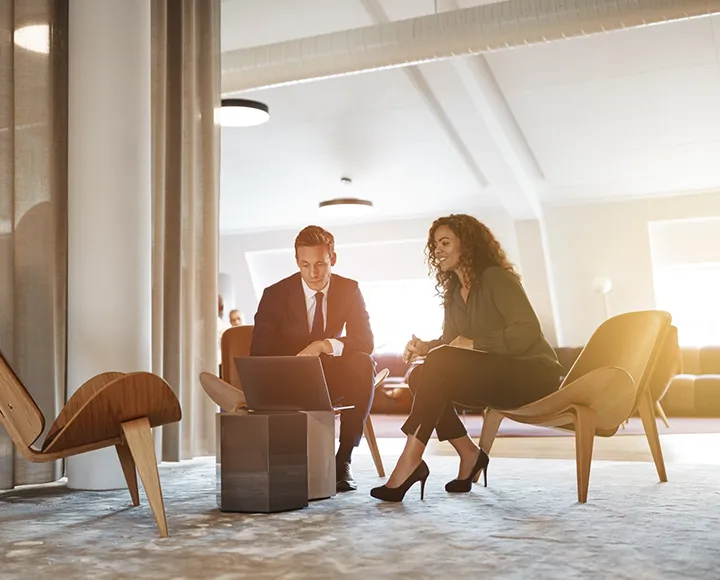 A man and woman having a meeting with their laptop A man and woman having a meeting with their laptop